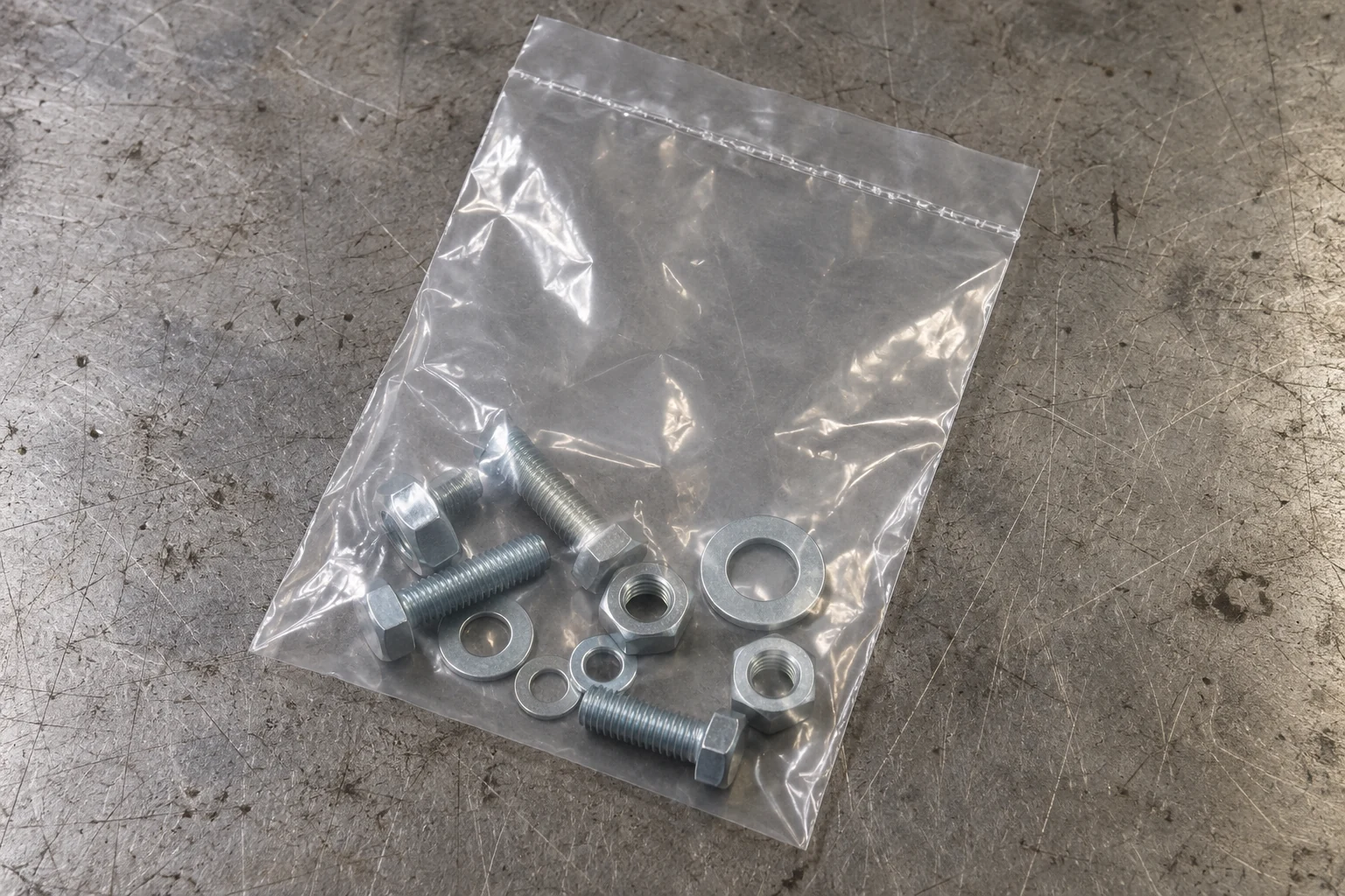 Transparent bag containing hardware below a straight top seal